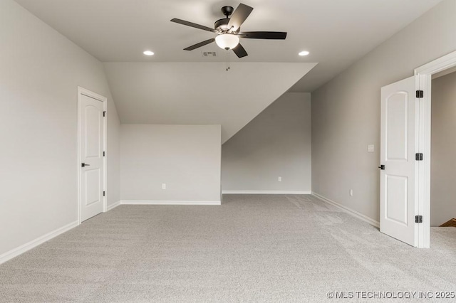 additional living space featuring ceiling fan, light colored carpet, and vaulted ceiling