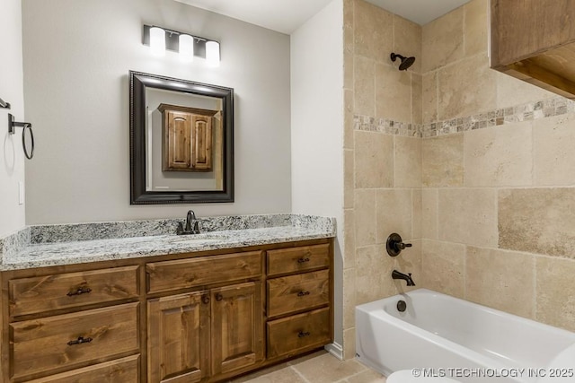 bathroom with vanity and tiled shower / bath