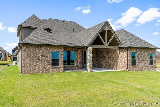 rear view of property featuring a patio area and a lawn