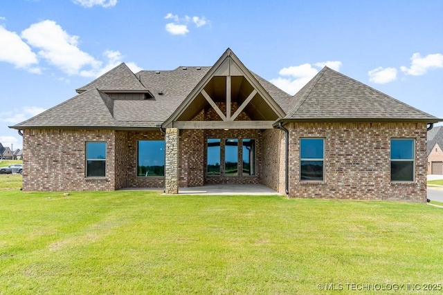 back of property with a lawn and a patio