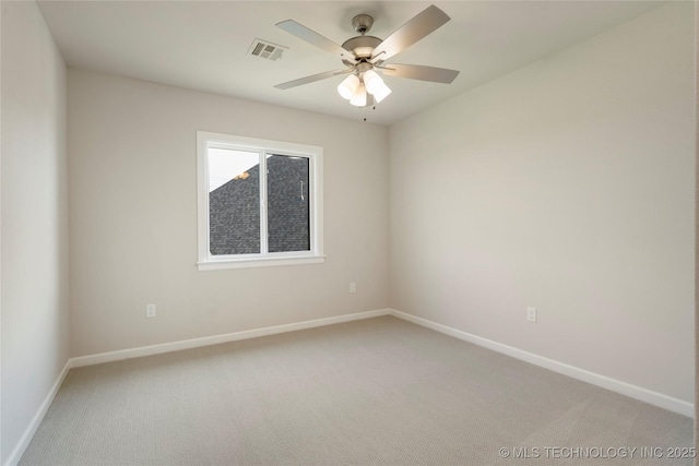 spare room featuring ceiling fan and carpet floors