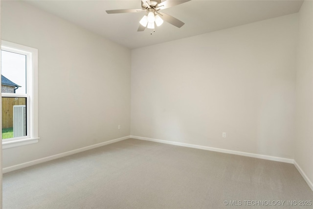 spare room with carpet floors and ceiling fan