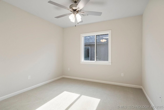 spare room featuring carpet and ceiling fan