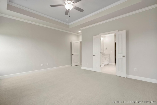 unfurnished bedroom with light carpet, a raised ceiling, ceiling fan, and ornamental molding