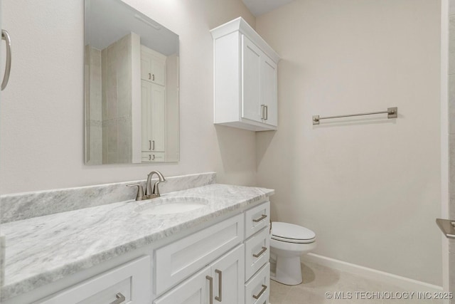 bathroom with tile patterned floors, vanity, and toilet