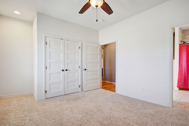 unfurnished bedroom featuring light colored carpet, ceiling fan, and a closet