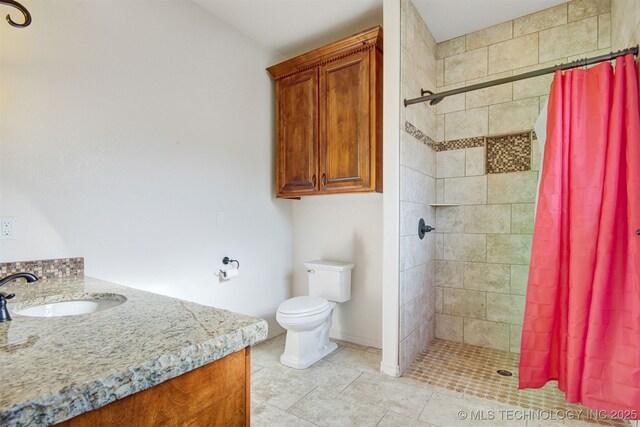 bathroom featuring vanity, toilet, and curtained shower