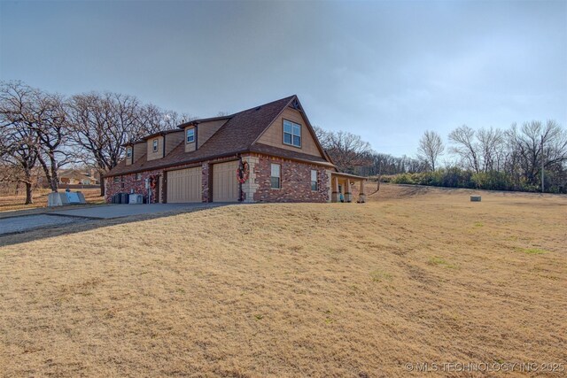 view of side of home featuring a garage and a yard