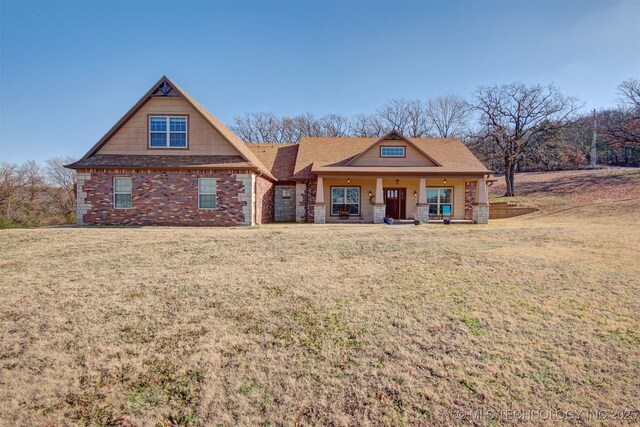 view of front of property featuring covered porch and a front lawn