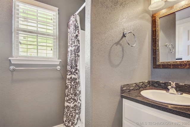 bathroom with vanity and curtained shower