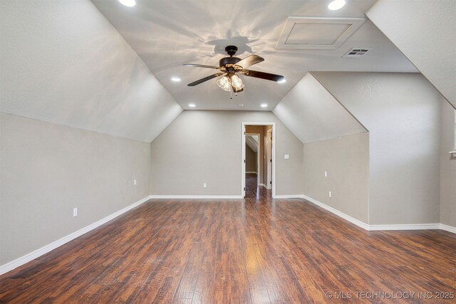 bonus room with vaulted ceiling and dark hardwood / wood-style flooring