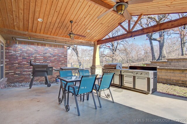 view of patio with ceiling fan, a grill, and exterior kitchen