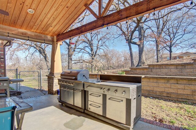 view of patio featuring area for grilling, sink, and an outdoor kitchen