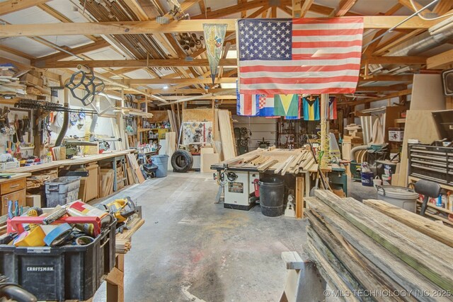 miscellaneous room featuring a workshop area and concrete floors