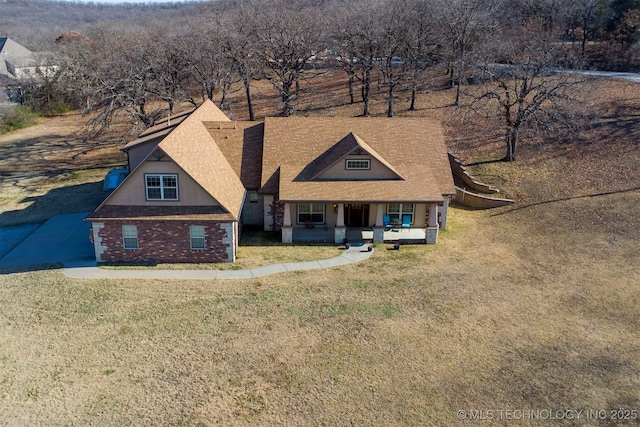 view of front of house with a porch and a front lawn