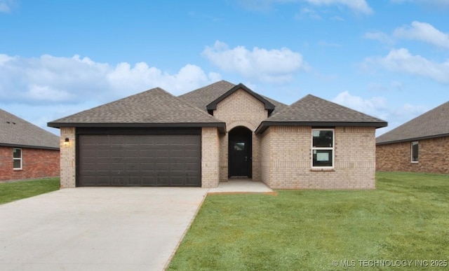 view of front of home featuring a garage and a front lawn