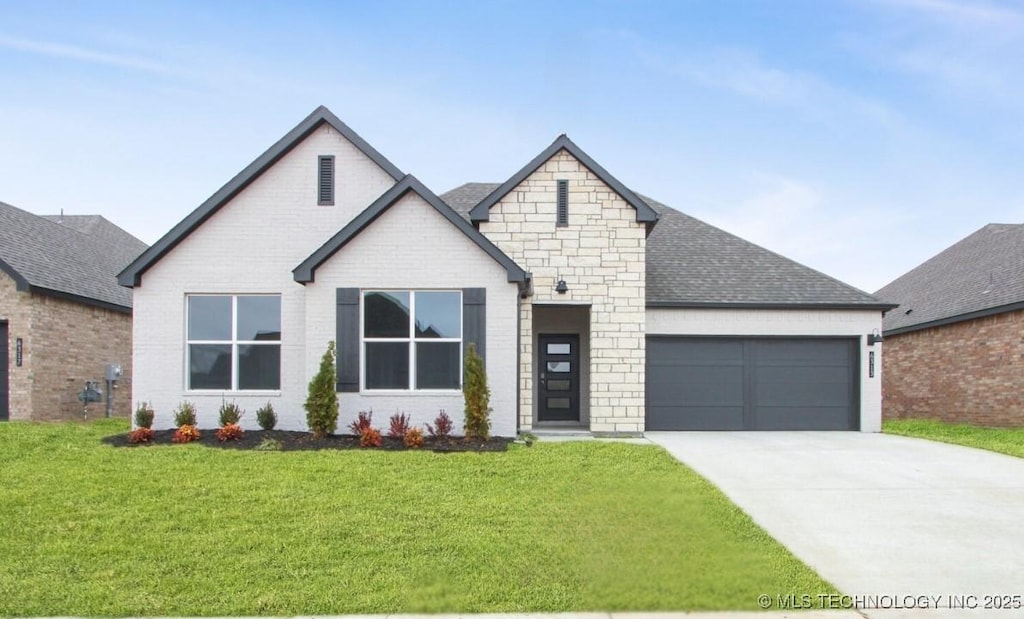 view of front of property featuring a garage and a front yard