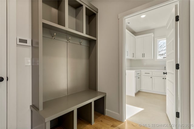 mudroom with light hardwood / wood-style flooring