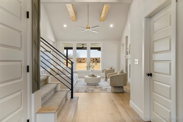 interior space featuring beam ceiling, light hardwood / wood-style floors, high vaulted ceiling, and ceiling fan