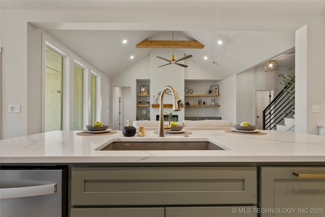 kitchen with lofted ceiling with beams, sink, ceiling fan, gray cabinets, and light stone counters