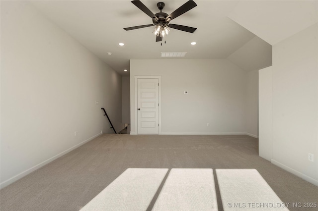 additional living space featuring ceiling fan, light colored carpet, and vaulted ceiling