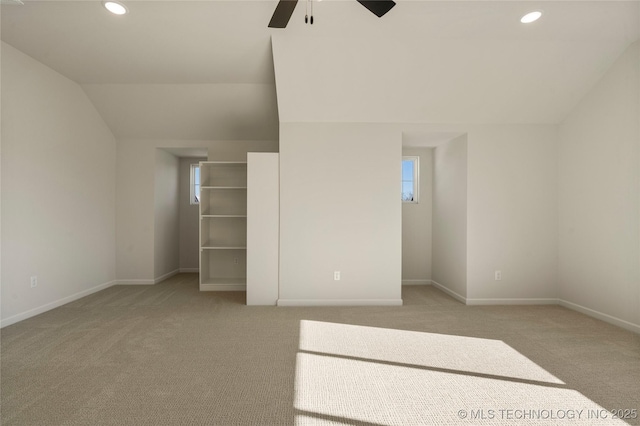 unfurnished bedroom with light colored carpet, ceiling fan, and lofted ceiling