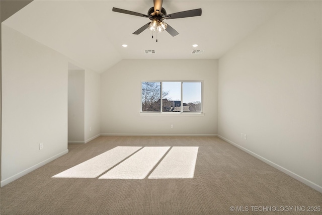 carpeted spare room with vaulted ceiling and ceiling fan