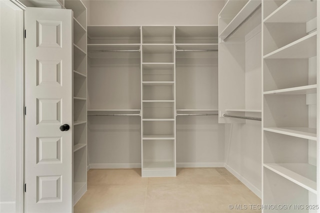 spacious closet featuring tile patterned flooring