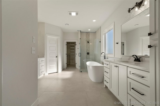 bathroom featuring vanity and independent shower and bath