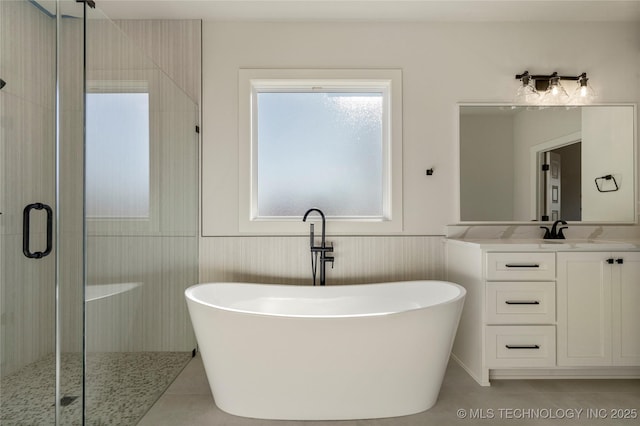 bathroom with vanity, tile patterned flooring, and plus walk in shower