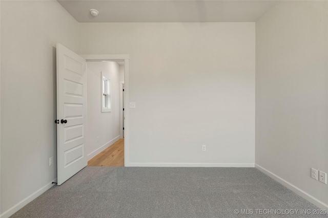 spare room featuring light colored carpet