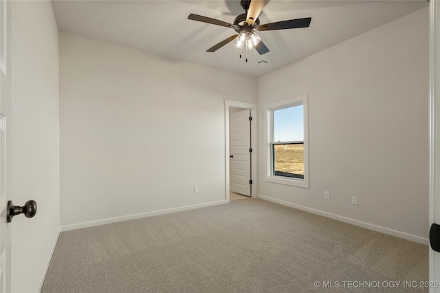 carpeted spare room featuring ceiling fan