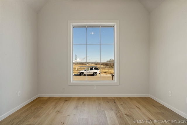 empty room with lofted ceiling and light wood-type flooring