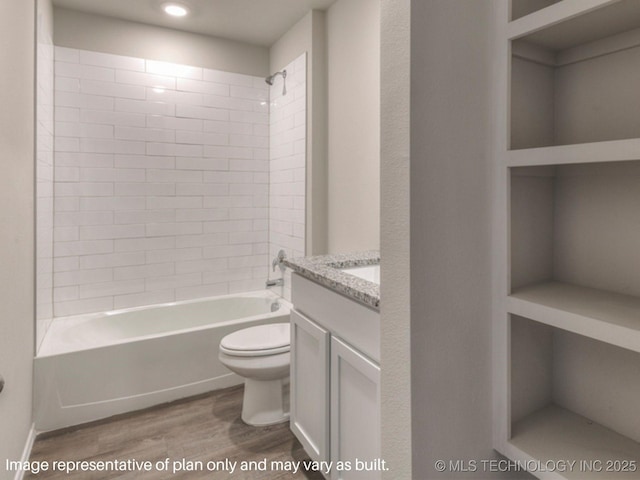 full bathroom featuring tiled shower / bath, wood-type flooring, vanity, and toilet