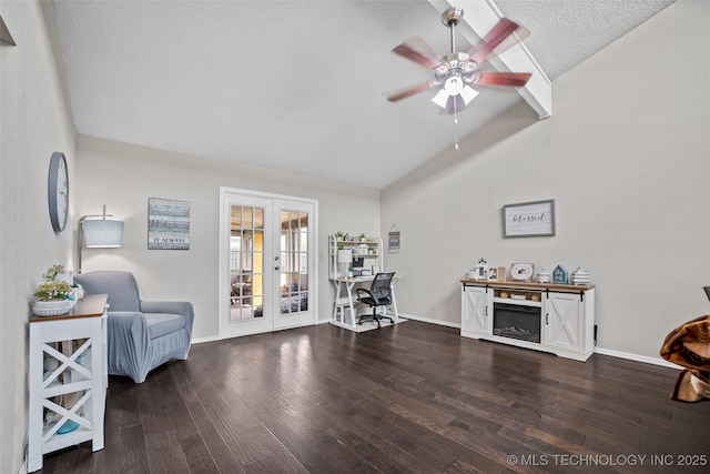 living area featuring ceiling fan, french doors, dark hardwood / wood-style floors, vaulted ceiling, and a textured ceiling