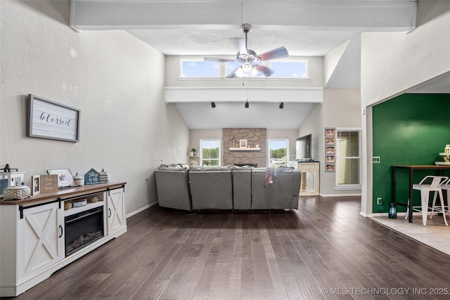 living room with ceiling fan, dark hardwood / wood-style flooring, and high vaulted ceiling