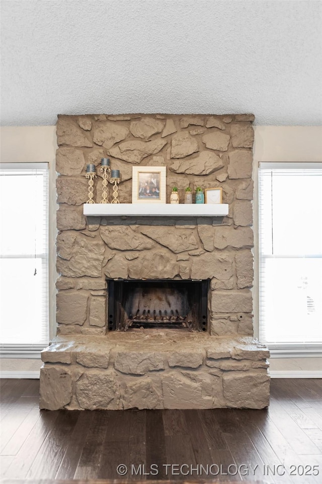 interior details with a fireplace, hardwood / wood-style floors, and a textured ceiling