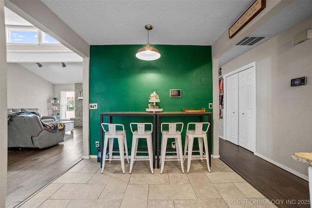 interior space featuring a textured ceiling and light hardwood / wood-style flooring