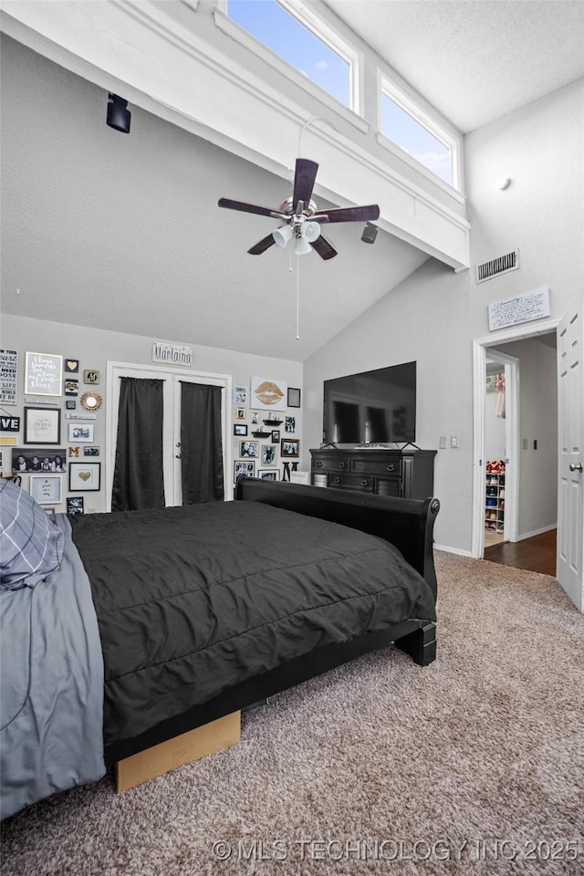 carpeted bedroom with ceiling fan and lofted ceiling