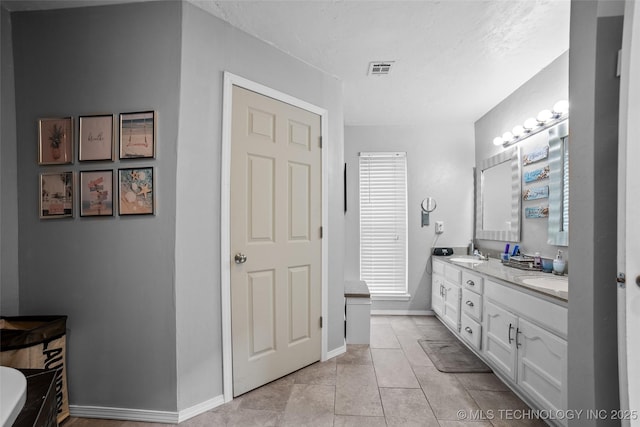 bathroom with tile patterned floors and vanity