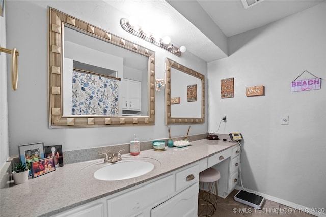 bathroom with tile patterned floors and vanity