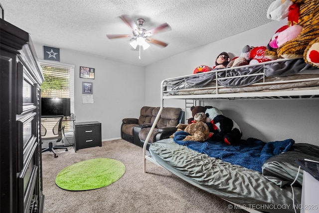 carpeted bedroom featuring ceiling fan and a textured ceiling