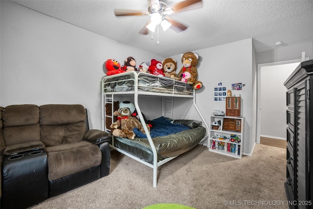 bedroom with ceiling fan, carpet floors, and a textured ceiling