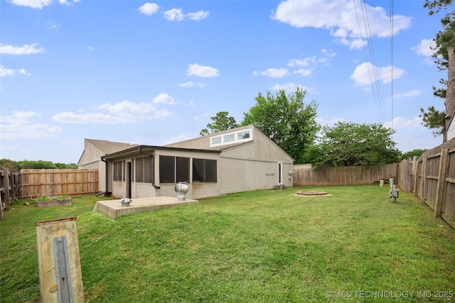 rear view of house featuring a yard