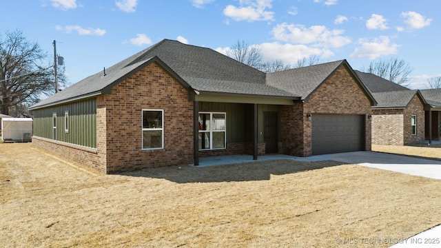 view of front of property with brick siding, board and batten siding, concrete driveway, roof with shingles, and a garage