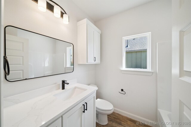 404 W 7th St, Dewey, OK 74029 - bathroom with toilet, vanity, baseboards, and wood finished floors