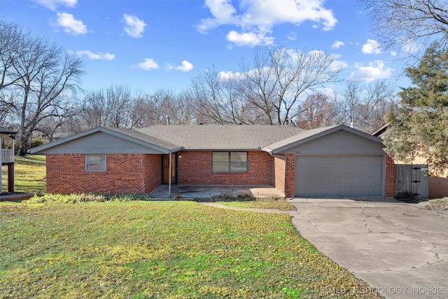 ranch-style house featuring a front yard and a garage