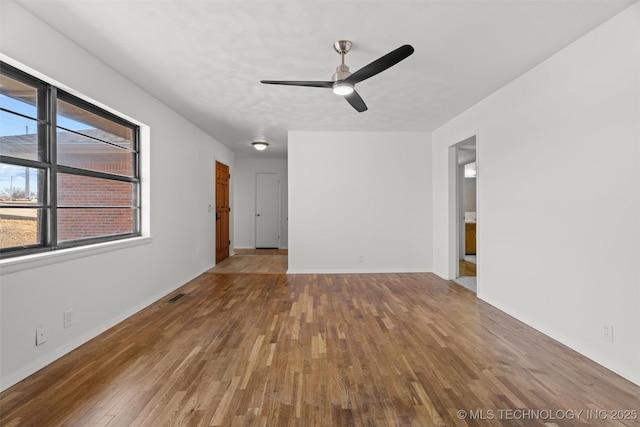 empty room with ceiling fan and wood-type flooring