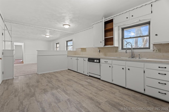 kitchen featuring tasteful backsplash, sink, light hardwood / wood-style flooring, dishwasher, and white cabinetry