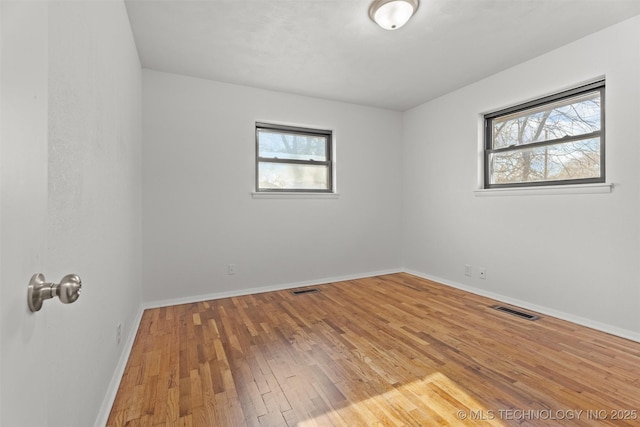 unfurnished room with hardwood / wood-style floors